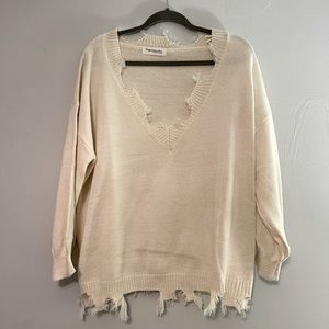 Distressed cream sweater